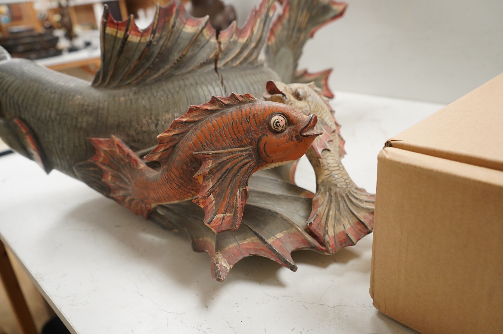 A large carved and painted wood hanging fish